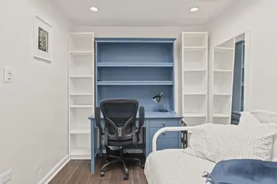 an office with a desk and a chair next to a bed at The Bella Vista Townhouse in Philadelphia