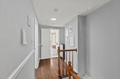 a hallway of a home with white walls and wood floors at The Bella Vista Townhouse in Philadelphia