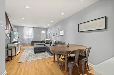 a living room with a table and a couch at The Bella Vista Townhouse in Philadelphia
