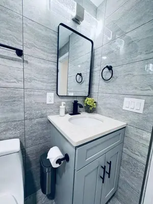 a bathroom with a sink and a mirror at Renovated Modern Apt next to ChinatownConvention in Philadelphia