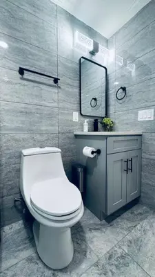 a bathroom with a white toilet and a mirror at Renovated Modern Apt next to ChinatownConvention in Philadelphia