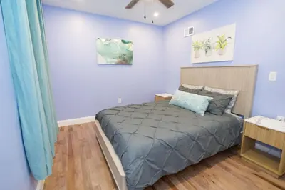 a bedroom with a bed in a room with blue walls at Renovated Modern Apt next to ChinatownConvention in Philadelphia