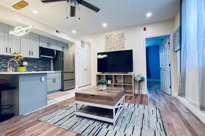 a living room with a large kitchen with a tv at New Apt w Washer Dryer Kitchen Rainfall in Chinatown in Philadelphia