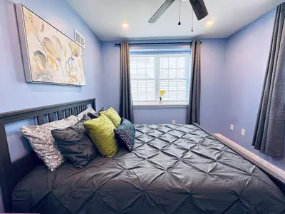 a bedroom with a bed with pillows and a window at New Apt w Washer Dryer Kitchen Rainfall in Chinatown in Philadelphia