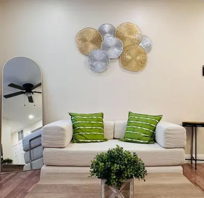 a living room with a white couch with green pillows at New Apt w Washer Dryer Kitchen Rainfall in Chinatown in Philadelphia