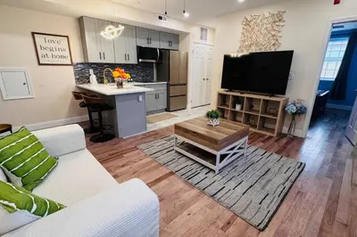 a living room with a couch and a table and a kitchen at New Apt w Washer Dryer Kitchen Rainfall in Chinatown in Philadelphia