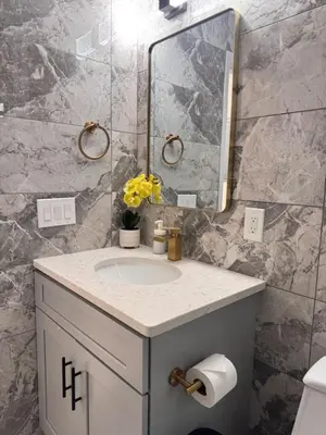 a bathroom with a sink and a mirror at New Apt w Washer Dryer Kitchen Rainfall in Chinatown in Philadelphia