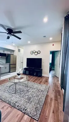 a living room with a ceiling fan and a table at Brand New Apt w Washer Dryer Kitchen Rainfall in Chinatown in Philadelphia