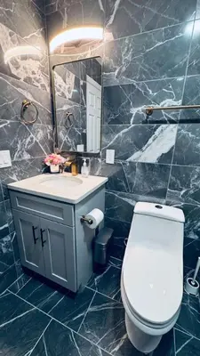 a bathroom with a toilet and a sink and a mirror at Brand New Apt w Washer Dryer Kitchen Rainfall in Chinatown in Philadelphia