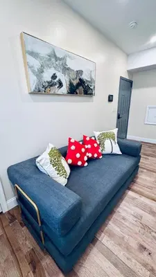 a blue couch in a living room with pillows on it at Brand New Apt w Washer Dryer Kitchen Rainfall in Chinatown in Philadelphia