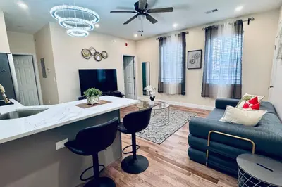a kitchen and living room with a couch and a table at Brand New Apt w Washer Dryer Kitchen Rainfall in Chinatown in Philadelphia