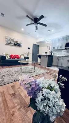 a living room with a ceiling fan and a vase of flowers at Brand New Apt w Washer Dryer Kitchen Rainfall in Chinatown in Philadelphia