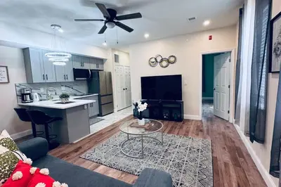a large living room with a kitchen and a table at Brand New Apt w Washer Dryer Kitchen Rainfall in Chinatown in Philadelphia