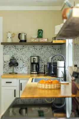a kitchen with a sink and a counter with oranges on it at Cozy Cottage in Glen Spey in Glen Spey