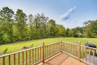 a wooden deck with a view of a field at 5 Mi to Susquehanna Boating! Secluded Log Cabin