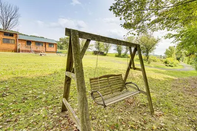 a swing in the middle of a field at 5 Mi to Susquehanna Boating! Secluded Log Cabin