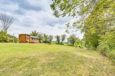 a house in the middle of a field at 5 Mi to Susquehanna Boating! Secluded Log Cabin