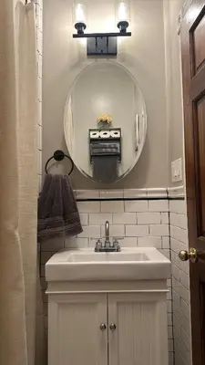 a bathroom with a sink and a mirror at Modern Comfort 1BR in Jersey City in Jersey City