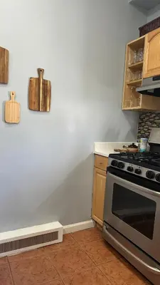 a kitchen with a stove and a counter top at Modern Comfort 1BR in Jersey City in Jersey City