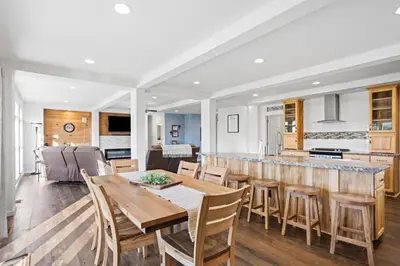 a kitchen and living room with a wooden table and chairs at Tioga's Peaceful Gem