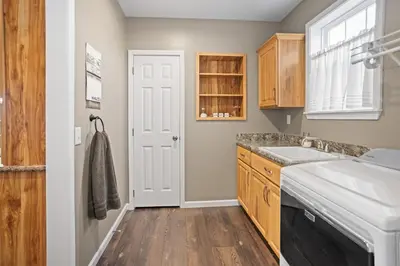 a kitchen with wooden cabinets and a sink at Tioga's Peaceful Gem