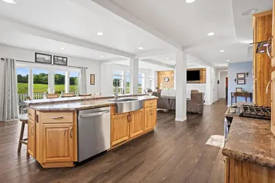 a kitchen with wooden cabinets and a large counter top at Tioga's Peaceful Gem