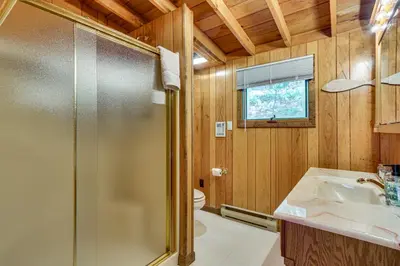 a bathroom with a shower and a sink and a toilet at Less Than 1 Mi to Lake Cabin with Hot Tub in Greentown! in Greentown