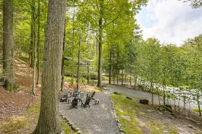 a group of benches sitting on a path in the woods at Less Than 1 Mi to Lake Cabin with Hot Tub in Greentown! in Greentown