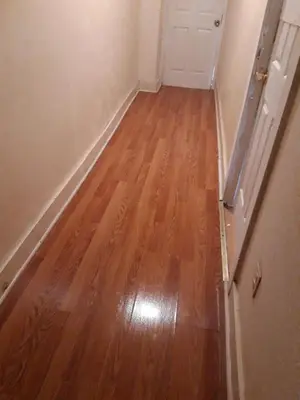 an empty room with a wooden floor and a door at 2131 Double Room with Private Bathroom in Philadelphia