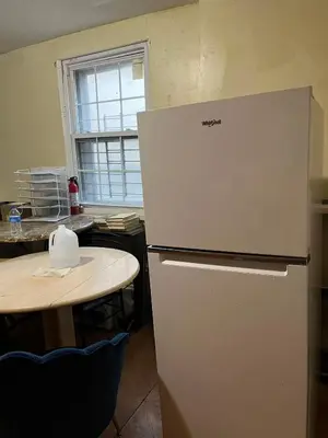 a white refrigerator in a kitchen with a table at 2131 queen room With shared Bathroom in Philadelphia