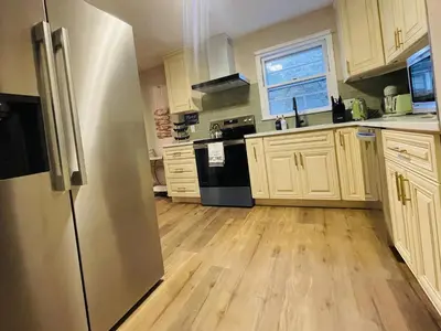 a kitchen with wooden floors and a stainless steel refrigerator at Private Estate, walk to Princeton downtown, 3 Bedrooms, 2 Bath, with Free Parking in Princeton