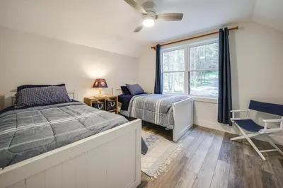 a bedroom with two beds and a window at Waterfront Home with Kayaks, Trails and Petting Zoo!