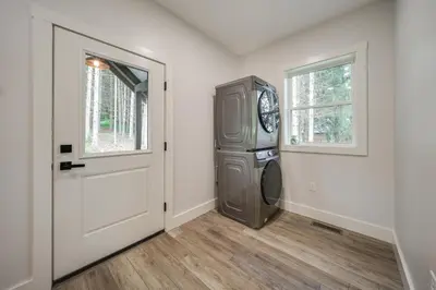 an empty room with a door and a clock at Waterfront Home with Kayaks, Trails and Petting Zoo!