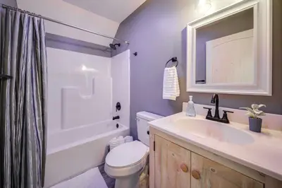 a bathroom with a sink and a toilet and a shower at Waterfront Home with Kayaks, Trails and Petting Zoo!
