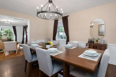 a dining room with a wooden table and chairs at Exclusive Lux Home Near Town • Game Rm • Gym • 4BR in Princeton
