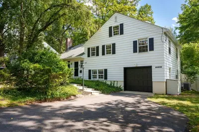 a white house with a garage and a driveway at Exclusive Lux Home Near Town • Game Rm • Gym • 4BR in Princeton