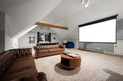a living room with leather couches and a projection screen at Family Oasis Pool Firepit Creek Near Delaware in Sparrow Bush