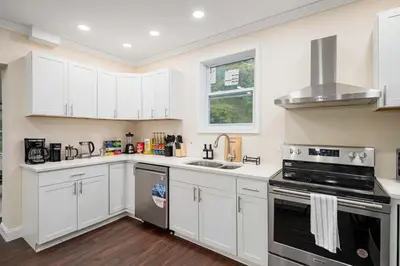 a kitchen with white cabinets and a stove top oven at Family Oasis Pool Firepit Creek Near Delaware in Sparrow Bush
