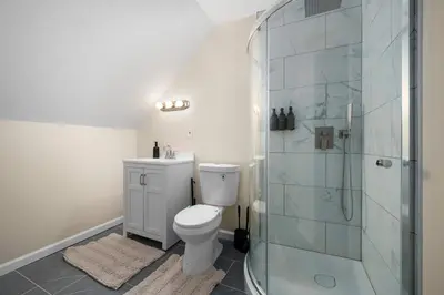 a bathroom with a toilet and a glass shower at Family Oasis Pool Firepit Creek Near Delaware in Sparrow Bush