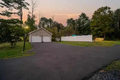 a parking lot with a garage in a driveway at Family Oasis Pool Firepit Creek Near Delaware in Sparrow Bush