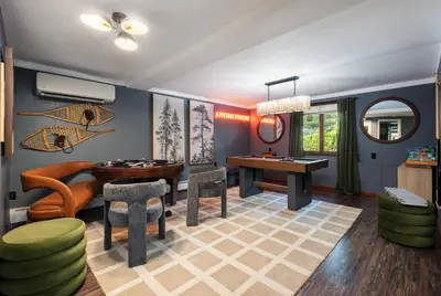 a living room with a table and chairs at Large Group Friendly 2 Game Rooms Indoor Sauna Hot Tub Near Jack Frost Ski Resort in Blakeslee