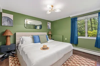 a bedroom with a bed with a hat on it at Large Group Friendly 2 Game Rooms Indoor Sauna Hot Tub Near Jack Frost Ski Resort in Blakeslee