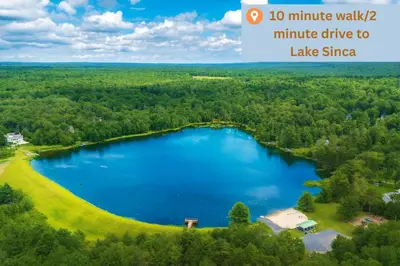 an aerial view of a lake in the woods at Large Group Friendly 2 Game Rooms Indoor Sauna Hot Tub Near Jack Frost Ski Resort in Blakeslee