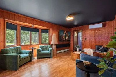a living room with wood paneled walls and a couch and chairs at Large Group Friendly 2 Game Rooms Indoor Sauna Hot Tub Near Jack Frost Ski Resort in Blakeslee