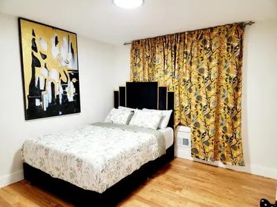a bedroom with a bed and a large curtain at Luxury 3BR Retreat Near NYC in Newark