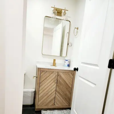 a bathroom with a sink and a mirror at Luxury 3BR Retreat Near NYC in Newark