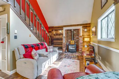 a living room with two couches and a staircase at Fishing, Fun and Fall Foliage! Pocono Lake Cabin in Pocono Lake
