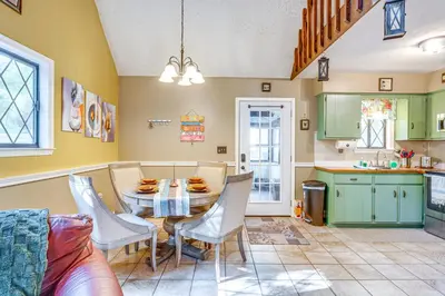 a kitchen with a table and chairs in a room at Fishing, Fun and Fall Foliage! Pocono Lake Cabin in Pocono Lake