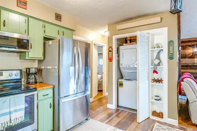a kitchen with green cabinets and a refrigerator at Fishing, Fun and Fall Foliage! Pocono Lake Cabin in Pocono Lake