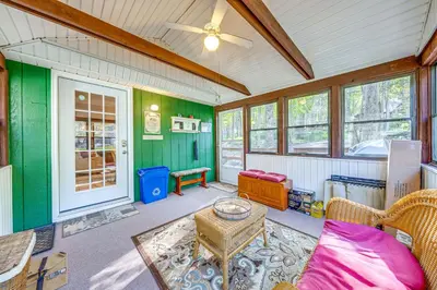 a living room with a couch and a table at Fishing, Fun and Fall Foliage! Pocono Lake Cabin in Pocono Lake